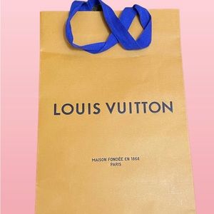 Three Louis Vuitton shopping totes with limited edition holiday ribbon.